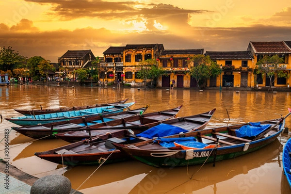 Fototapeta Traditional boats in front of ancient architecture in Hoi An, Vietnam.