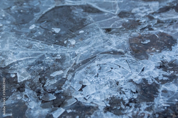 Fototapeta A background of an icy puddle with the ice broken