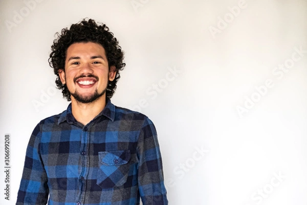 Fototapeta Latin American man smiling, neutral background 