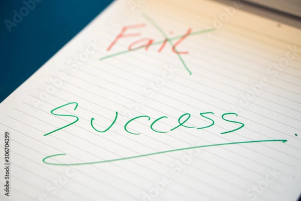 Fototapeta Fild text with a hand with a red pen And crossed out with a green pen on the notebook. Success message by hand with a green pen below the fail. The concept of ​​not giving up on failure.