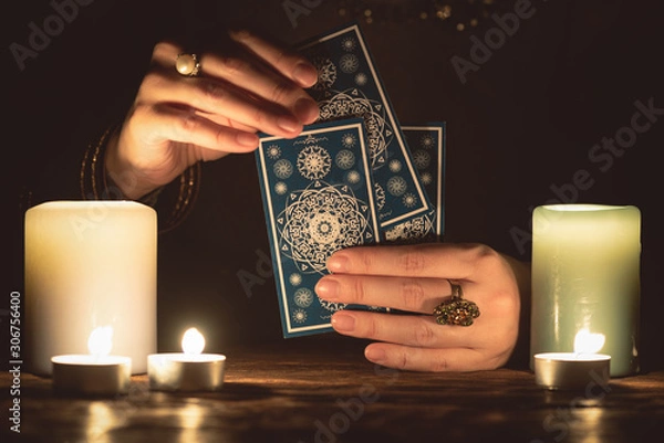 Fototapeta Fortune teller with tarot cards in hands close up. Future reading concept.