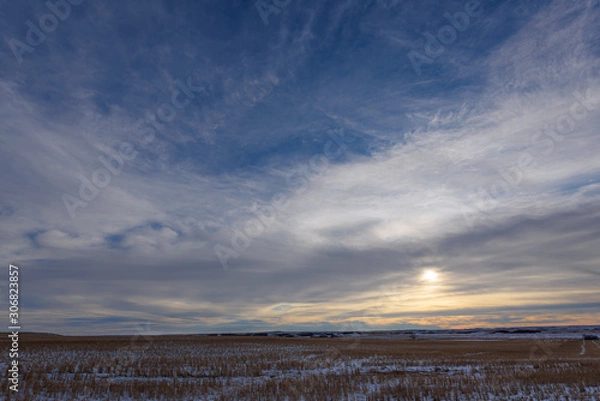 Fototapeta sun setting behind clouds