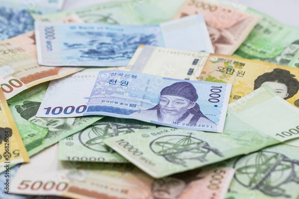 Fototapeta Korean currency.Pile of various currencies isolated on white background.South Korean Won Currency.