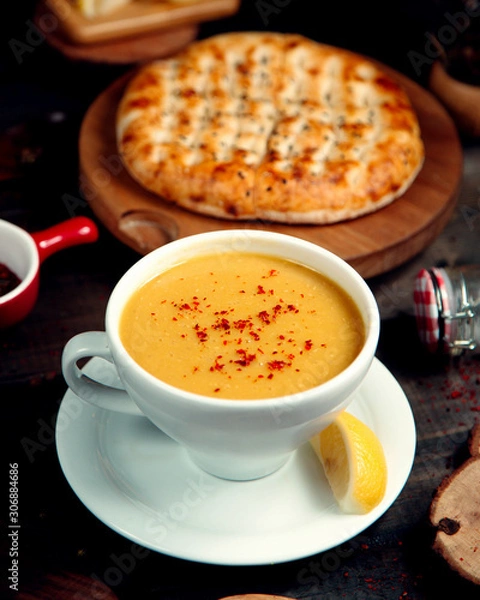 Fototapeta lentil soup in a bowl for soups and a slice of lemon