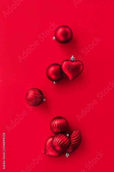 Fototapeta Juggling Christmas round balls and heart shape. Creative holiday minimalistic composition. The concept of festive fun and New Year's mood. Vertical flat lay pattern banner for social network Instagram