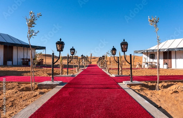 Fototapeta Red Carpet Main path between the tents of luxury Golden Camp site in Sahara Desert Merzouga, Morocco on a sunny day