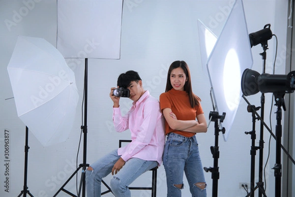 Fototapeta Couple model with camera in photograph studio background