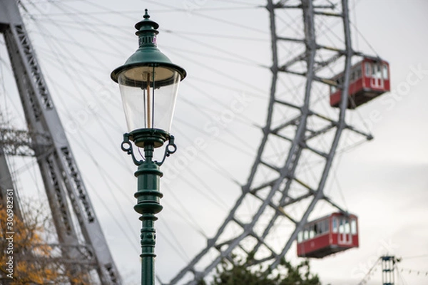 Fototapeta Lamp in front of Wiener Riesenrad on a cloudy day in winter