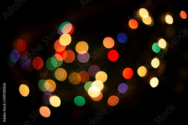 Fototapeta blur light bokeh color red green yellow on background black.