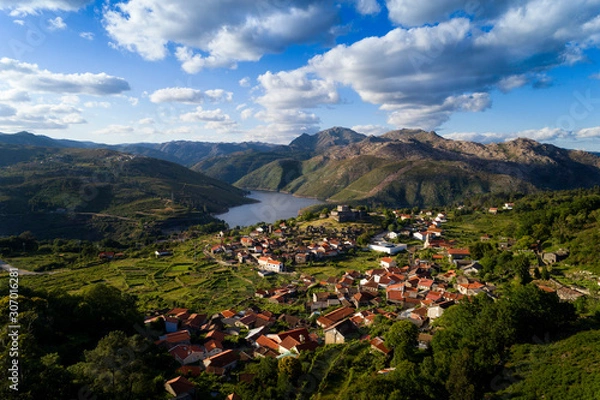Fototapeta Aerial panoramic view of the historic village of Lindoso, with the surroundings mountains and lake, at the Peneda Geres National Park, in Portugal.