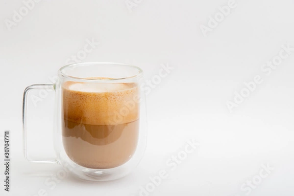 Fototapeta Hot Latte in double layer clear glass on white background