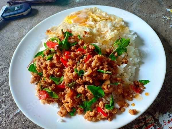 Fototapeta Stir-fried pork with basil leaves