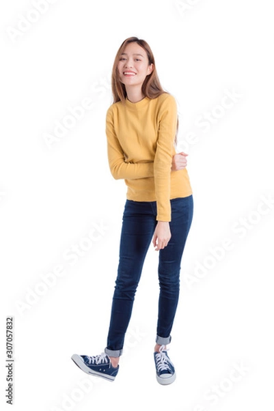 Obraz Full length of young asian beautiful girl standing and smiles over white background