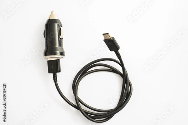 Fototapeta black car charger with USB output connection cable. A photo taken on a black car charger with USB output connection cable against a white backdrop