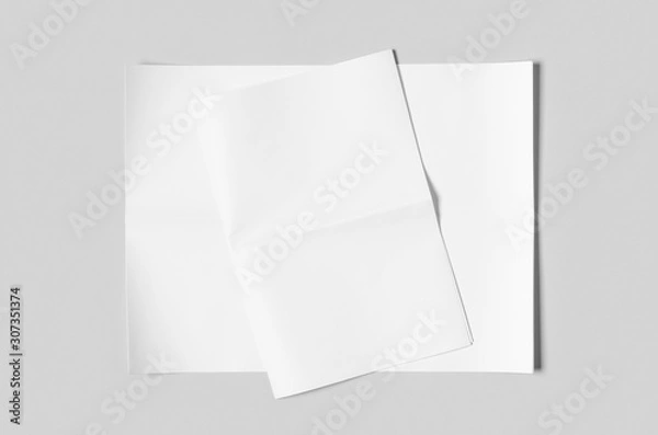 Fototapeta Blank newspaper mockup on a grey backgound.