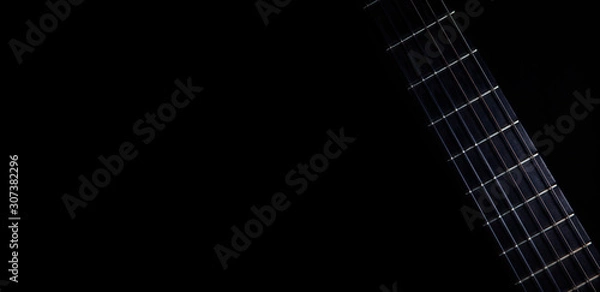 Fototapeta Classical guitar fretboard with strings on black background