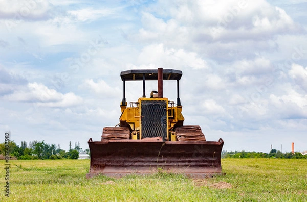 Fototapeta Old rusty tractor in field