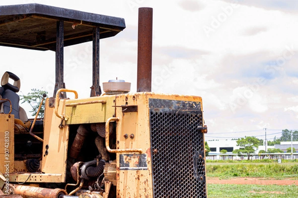 Obraz Old rusty tractor in field
