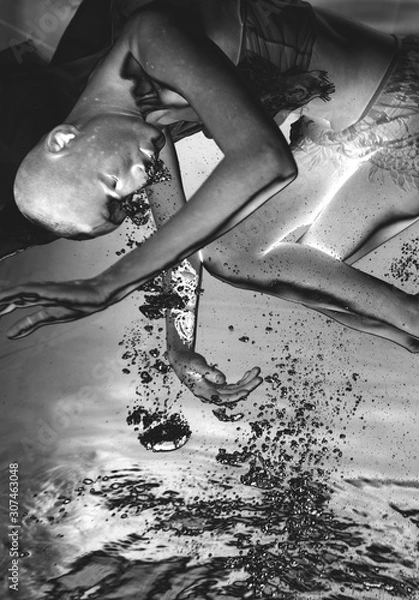Fototapeta Very Strange photos of an alien girl underwater with bubbles in the negative.