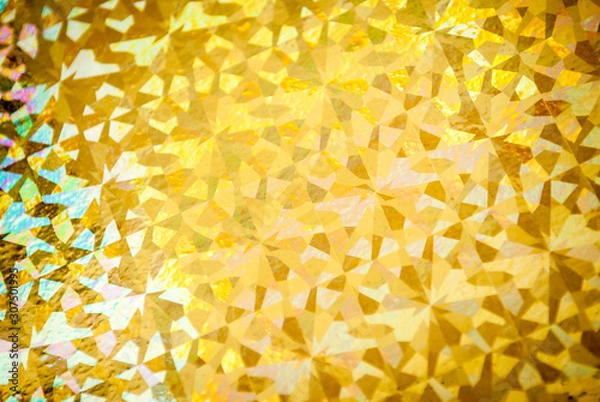 Fototapeta Shiny gold foil holiday wrapping paper  background with geometric pattern in full frame close-up