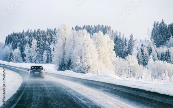Obraz Car on Winter road with snow in Finland. Auto and Cold landscape of Lapland. Automobile on Europe forest. Finnish City highway ride. Roadway and route snowy street trip. Driving