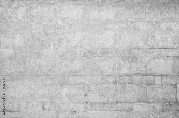 Fototapeta Old and weathered wall made of stone blocks in black and white. High resolution full frame textured background.