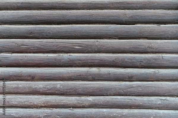 Fototapeta An element of the architecture of an old wooden house made of logs.
