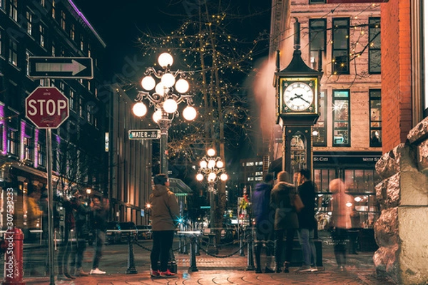 Fototapeta The famous Steam Clock in Gastown in Vancouver city with cars light trails at night