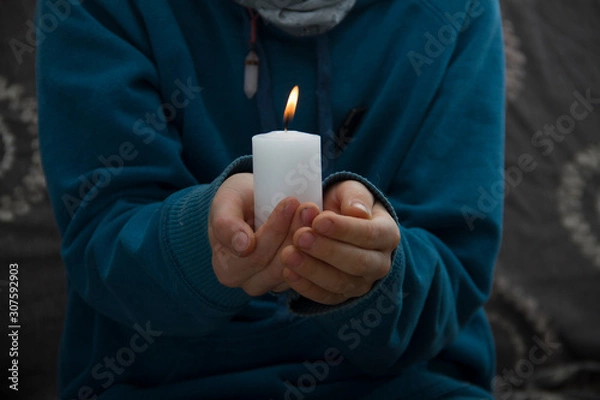 Obraz man holding a candle