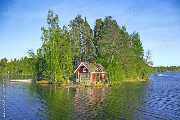 Obraz Island on lake in Finland with red summer cottage