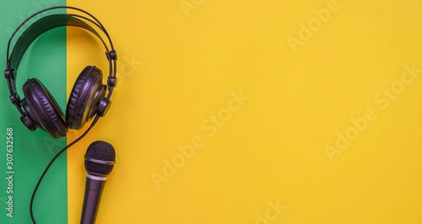 Fototapeta Microphone and headphone on a yellow background