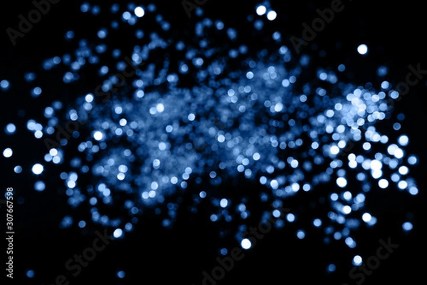 Fototapeta Blue sparkling abstract background. Festive concept. Color 2020 concept.