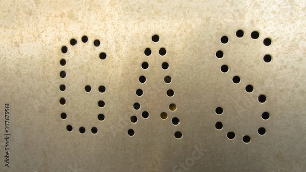 Fototapeta  inscription "gas" engraved in metal by holes 