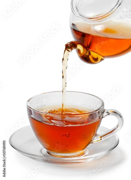 Obraz Tea being poured into glass tea cup isolated on a white backgrou