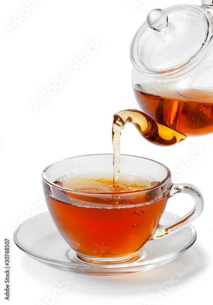 Obraz Tea being poured into glass tea cup isolated on a white backgrou