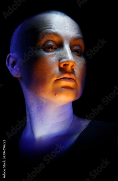 Fototapeta Artistic portrait of a lady created by multicolor light on a black background