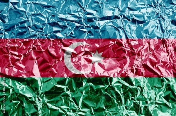 Obraz Azerbaijan flag depicted in paint colors on shiny crumpled aluminium foil closeup. Textured banner on rough background