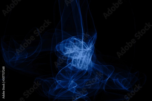 Fototapeta Blue neon intertwined smoke. Isolated on black background. Color of the year 2020 concept. Abstract black background. Neon lights texture.