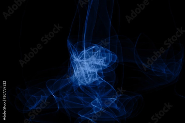 Fototapeta Blue neon intertwined smoke. Isolated on black background. Color of the year 2020 concept. Abstract black background. Neon lights texture.