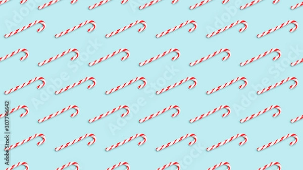 Fototapeta Seamless background pattern of christmas candy cane isolated on azure