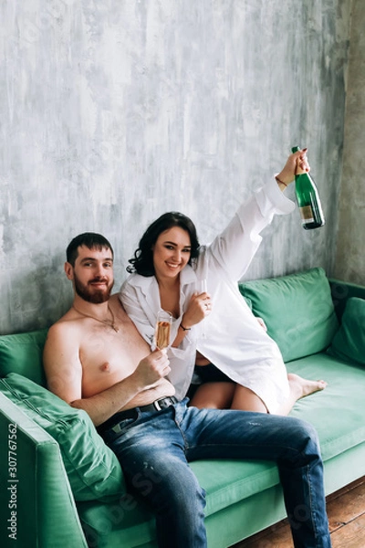 Obraz couple celebrating new year, green sofa, cozy at home