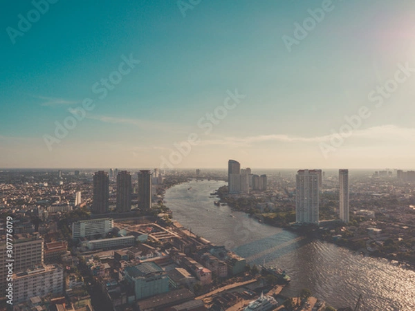 Fototapeta Aerial view of Bangkok skyline and skyscraper on Sathorn Road center of business in Bangkok downtown.Taksin Bridge over Chao Phraya River Bangkok at Thailand