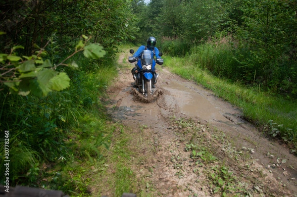Fototapeta Travelling on an enduro motorcycle in the taiga.