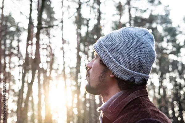 Obraz Man looking up in a forest, hopeful expression, 