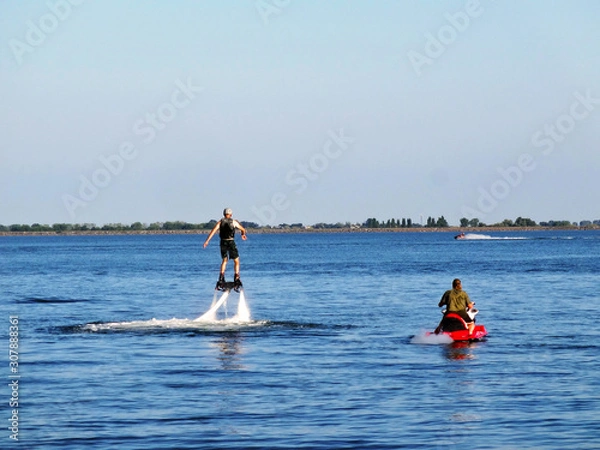 Fototapeta Sports activities on the lake in the recreation center in summer