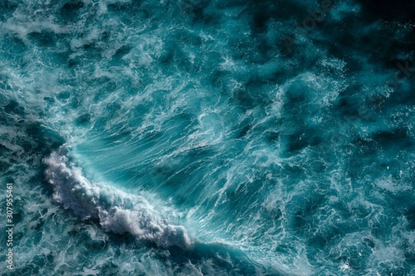 Fototapeta Aerial view to seething waves with foam backlit by the setting sun. Bali, Indonesia.