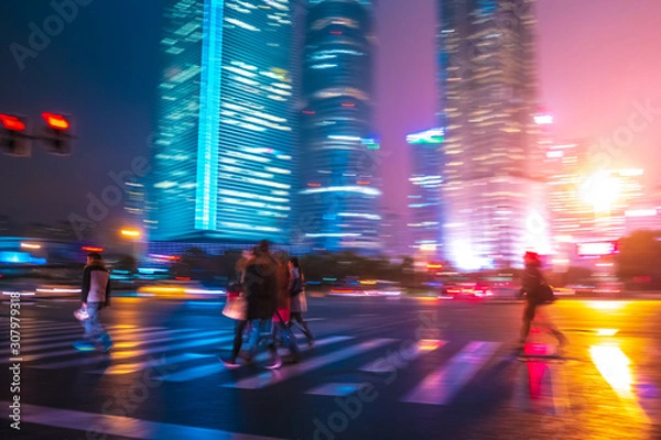 Obraz Abstract background of People across the crosswalk at night in Shanghai, China.