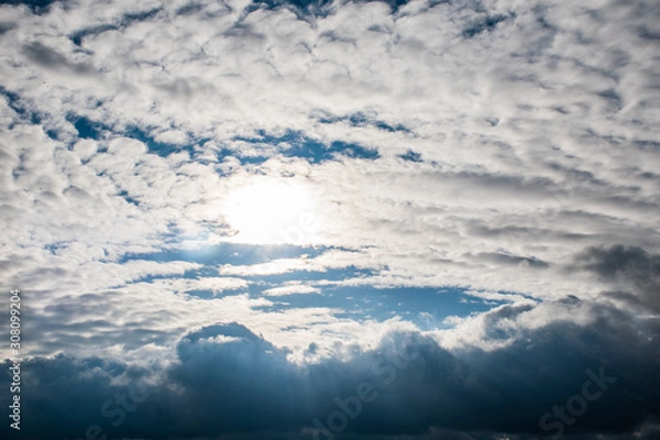Fototapeta the sun's rays shine through the clouds. cloudy sky, background