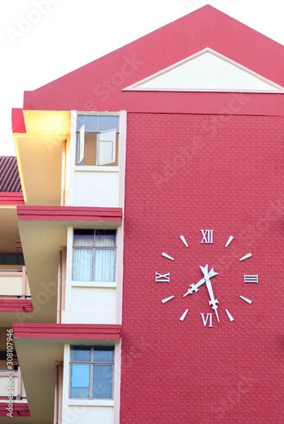 Obraz The clock on the red building background