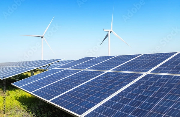Fototapeta Solar panels and wind turbines generating electricity is solar energy and wind energy in hybrid power plant systems station use renewable energy to generate electricity with blue sky 